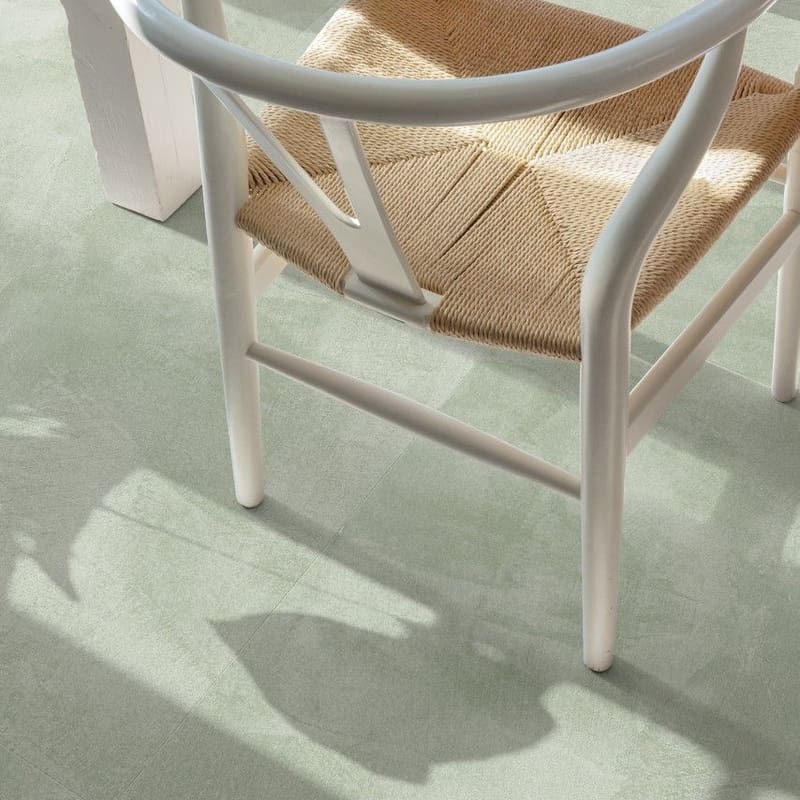 Soft Sage vinyl flooring in a dining area with wooden table and woven chair