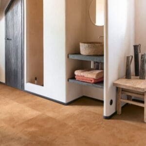 Quick-Step Muse Terracotta Laminate Flooring MUS5490 installed in a bathroom with white walls