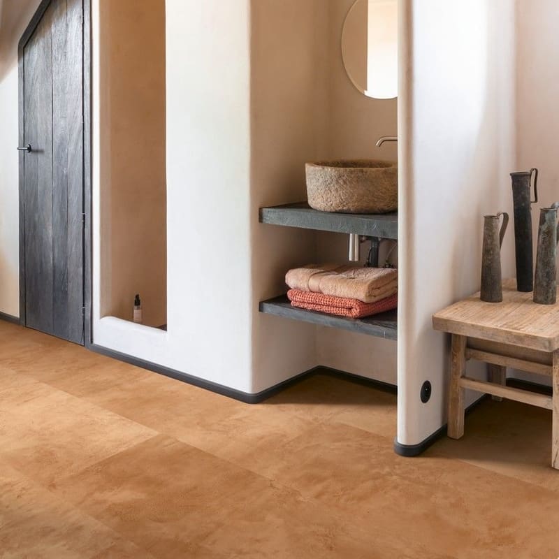 Quick-Step Muse Terracotta Laminate Flooring MUS5490 installed in a bathroom with white walls