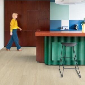 Child drawing on floor with Sea Breeze Oak Beige vinyl flooring