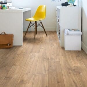 Home office with Quick-Step Classic Midnight Oak Natural laminate flooring, white desk and yellow chair