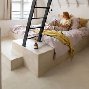 Bedroom with white sloped ceiling and Sandstone Concrete flooring