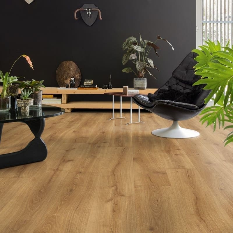 Close-up of Quick-Step Desert Oak Warm Natural laminate flooring showing textured grain and beveled edges