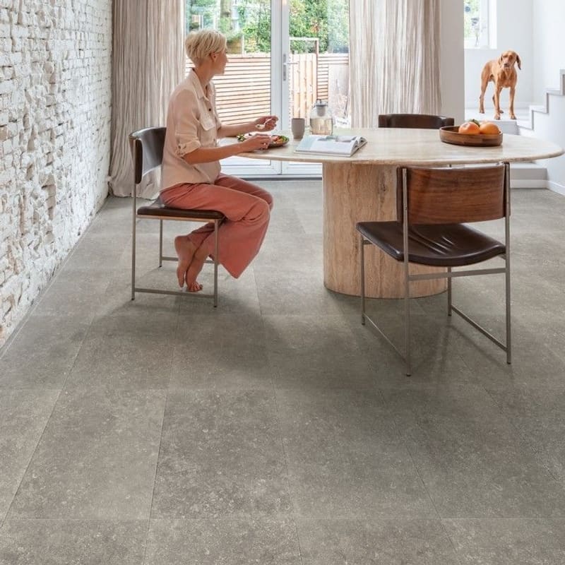 Sunroom with Dusky Bluestone laminate flooring, wood ceiling and wood-burning stove