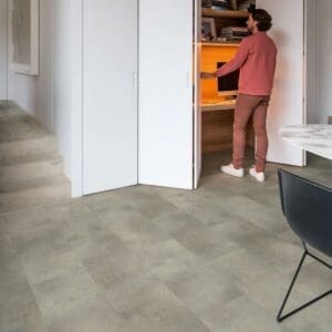 Rustic entryway with brick walls and Quick-Step Alpha Oro Concrete Rock flooring