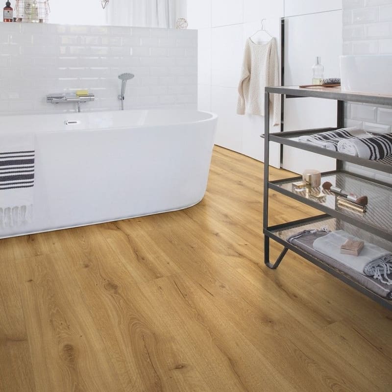 Quick-Step Desert Oak Warm Natural laminate flooring installed in a contemporary bathroom with freestanding bath