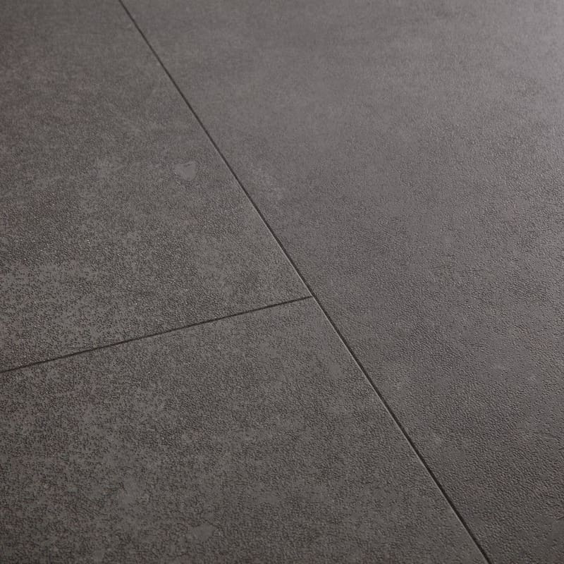 Close-up of Quick-Step Alpha Oro Volcanic Rock vinyl flooring showing detailed stone texture and finish