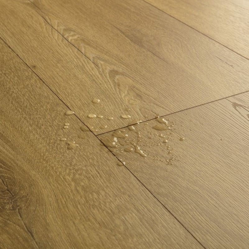 Close-up of water droplets on waterproof honey oak laminate flooring