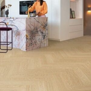 Contemporary kitchen with Quick-Step Alpha Ciro Pure Oak Blush flooring and marble countertops