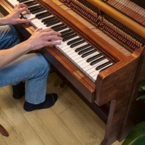 Piano on Quick-Step Honey Brown Oak laminate flooring in a home setting