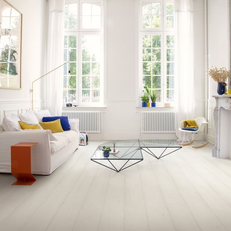 Living room with white laminate flooring, grey sofa, indoor plant and wall art