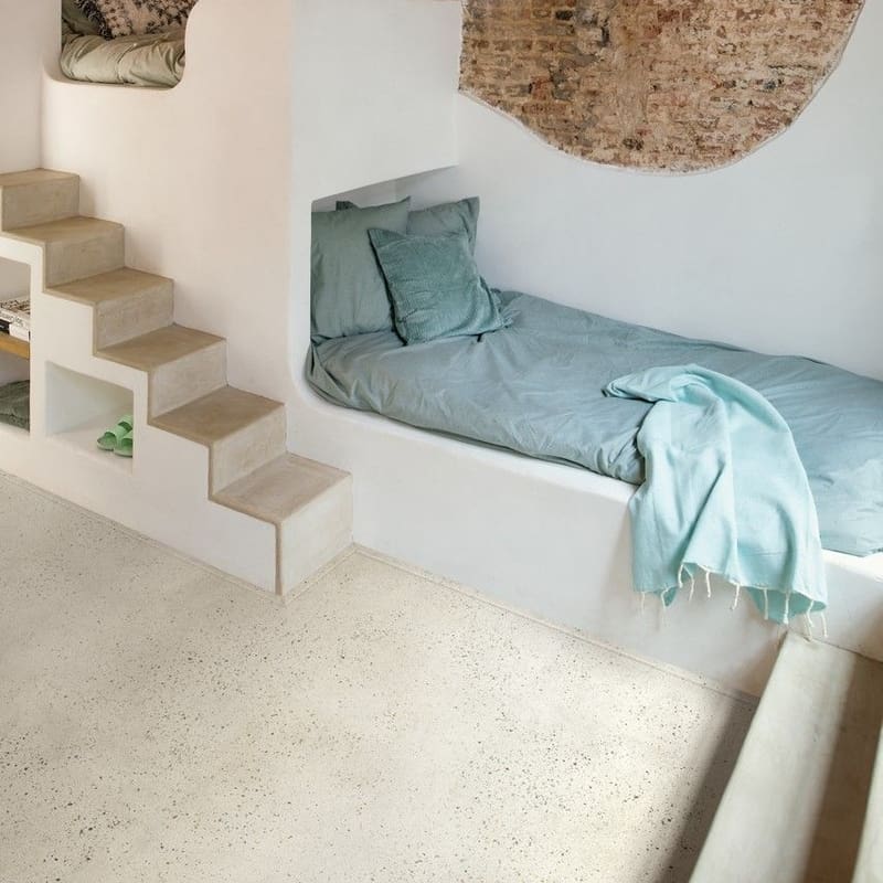 Built-in sleeping nook with Quick-Step Pebble Concrete flooring and exposed brick wall