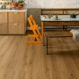 Kitchen dining area with Quick-Step Botanic Caramel Oak flooring and white brick wall
