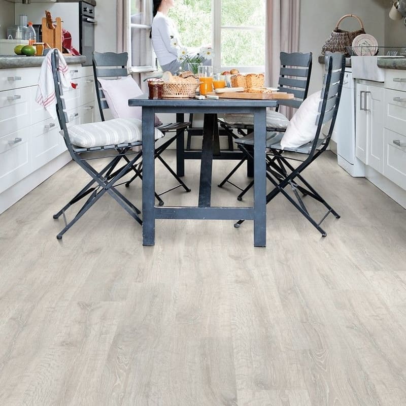Quick-Step Classic Reclaimed White Patina Oak CL1653 laminate flooring in a home office setting with natural light