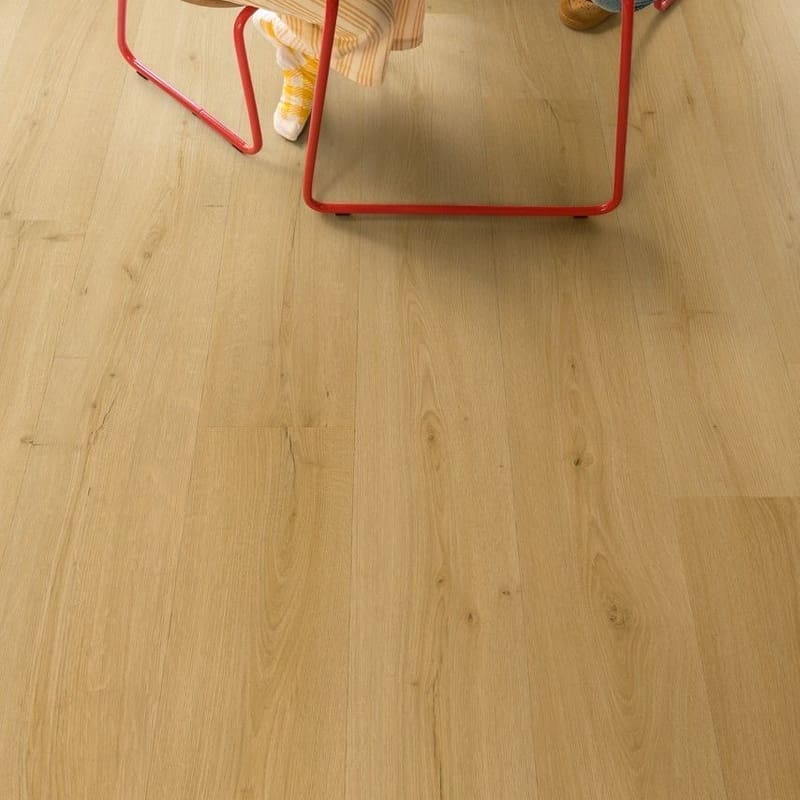 Child drawing at table on Quick-Step Alpha Bloom Brushed Oak Honey vinyl flooring