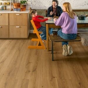Kitchen dining area with Quick-Step Botanic Caramel Oak flooring and family meal time