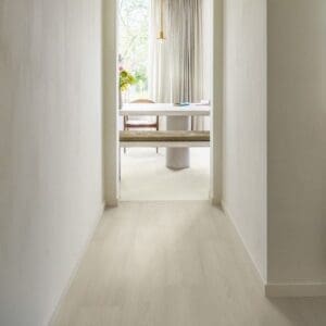 White Premium Oak laminate flooring installed in a bright hallway leading to a dining area