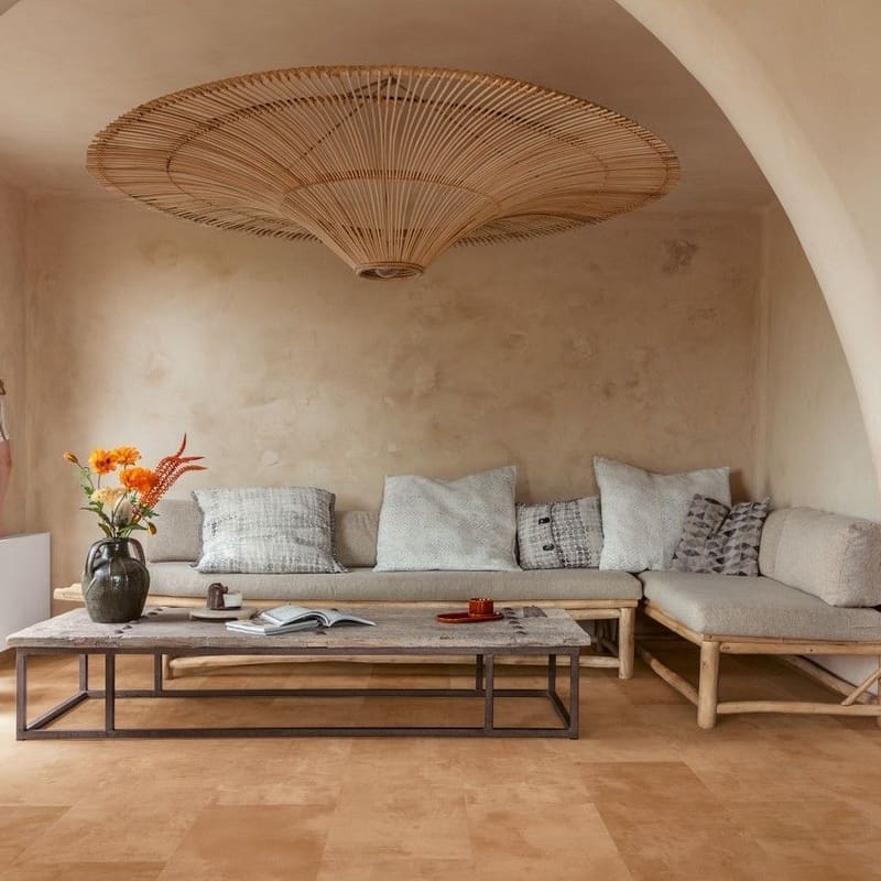 Quick-Step Muse Terracotta Laminate Flooring MUS5490 in a living room with arched ceiling and natural decor