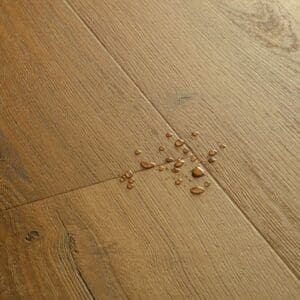 Close-up detail of Quick-Step Botanic Caramel Oak flooring showing grain texture and plank joints