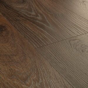 Close-up of Quick-Step Peanut Brown Oak laminate showing water resistance properties