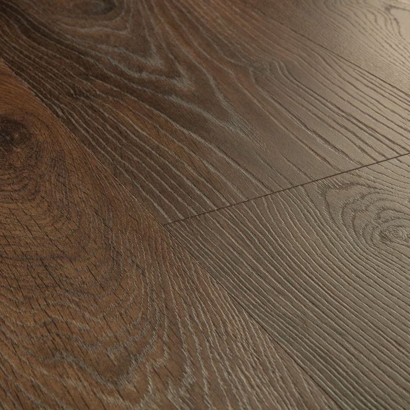 Close-up of Quick-Step Peanut Brown Oak laminate showing water resistance properties