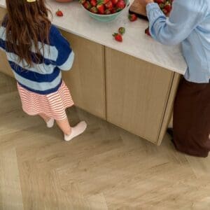 Quick-Step Alpha Ciro Botanic Beige Herringbone flooring in modern bathroom with peach walls