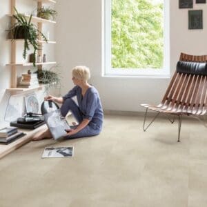 Living room with white brick wall and Sandstone Concrete flooring