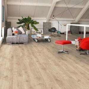 Quick-Step Creo Virginia Oak Natural laminate flooring installed in a modern loft space with white ceiling beams and contemporary furniture