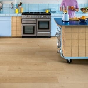 Kitchen with colorful cabinetry and Coast Oak Beige flooring showing versatile design compatibility