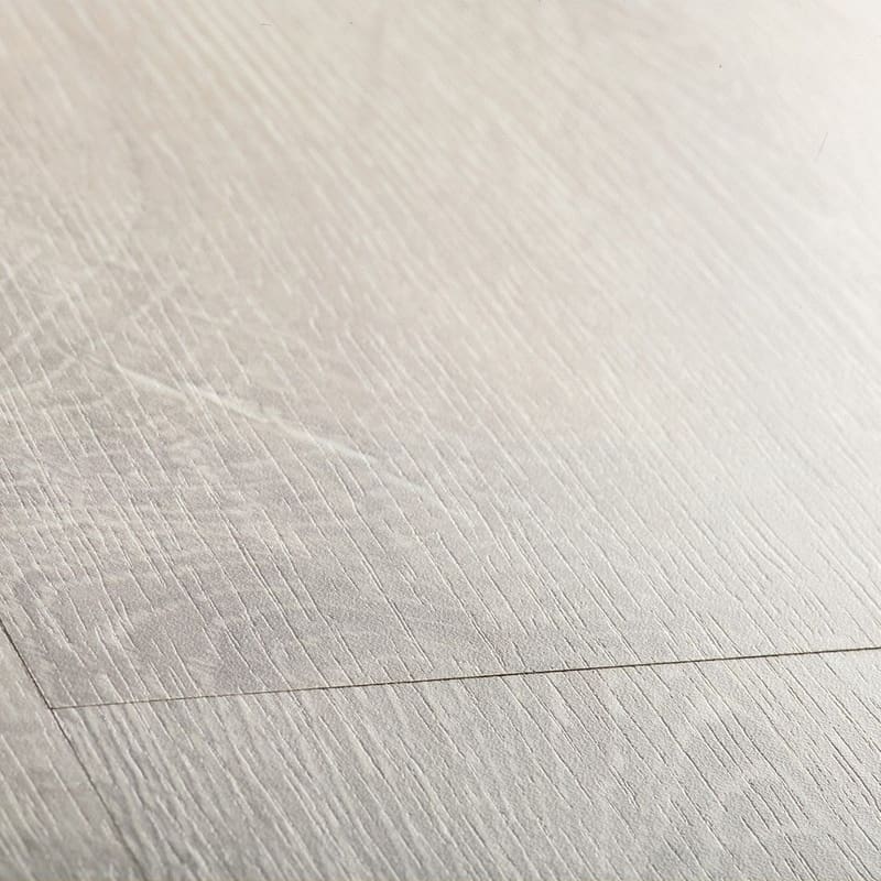 Quick-Step Classic Reclaimed White Patina Oak CL1653 laminate flooring installed in a bright kitchen with dining area