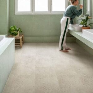 Oyster Concrete vinyl flooring in a contemporary living space with plants and neutral decor