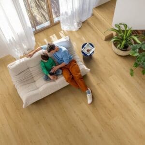 Close-up of embossed wood grain texture of Quick-Step Alpha Bloom Brushed Oak Honey vinyl flooring