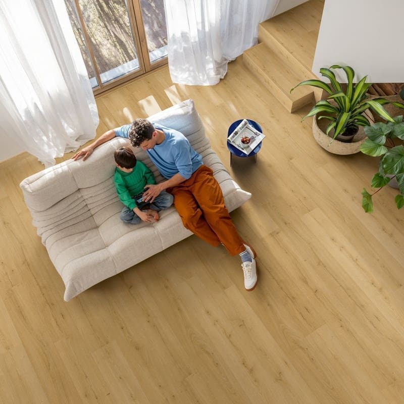 Close-up of embossed wood grain texture of Quick-Step Alpha Bloom Brushed Oak Honey vinyl flooring