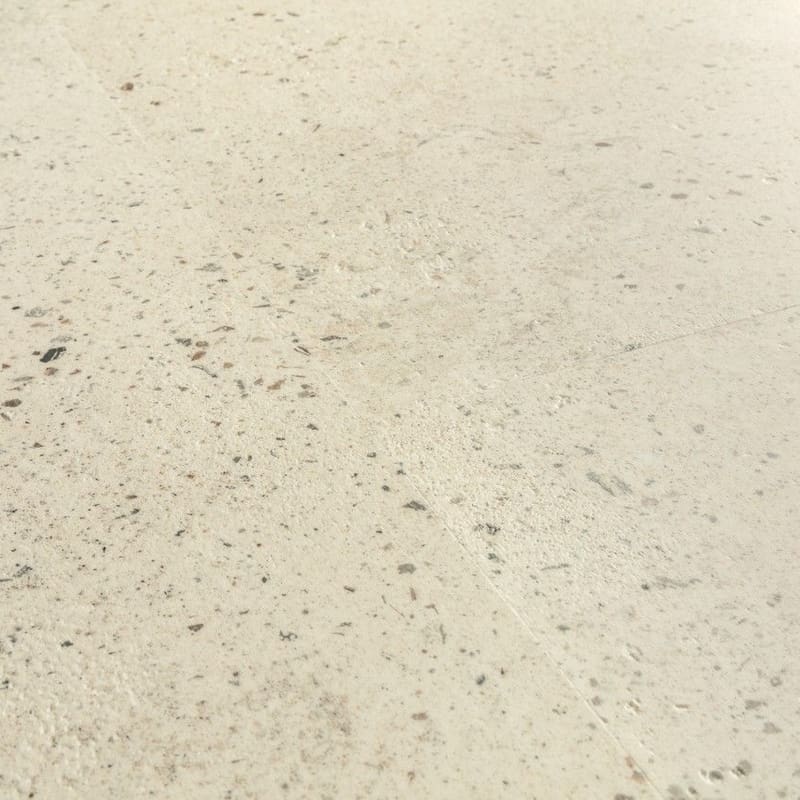Close-up of Quick-Step Pebble Concrete flooring with water droplets showing waterproof properties