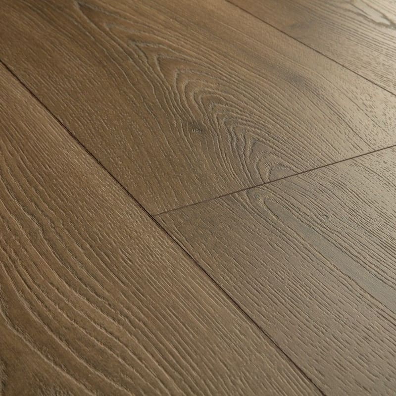 Full room view of Quick-Step Warm Brown Oak laminate flooring installation showing plank layout