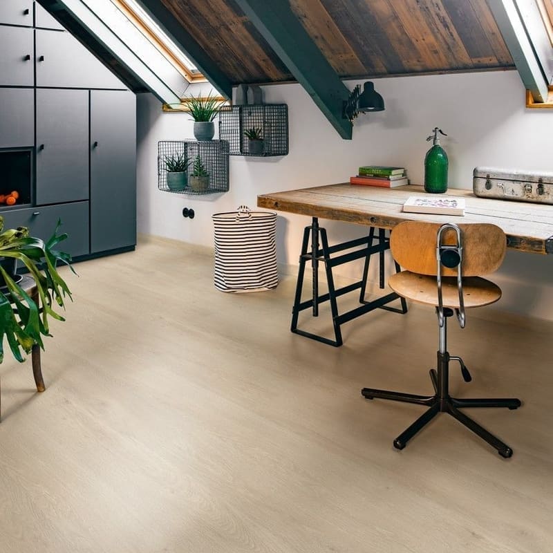 Person sitting at kitchen counter with Sea Breeze Oak Beige flooring
