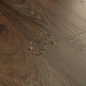 Detailed view of Quick-Step Peanut Brown Oak laminate flooring texture and grain pattern
