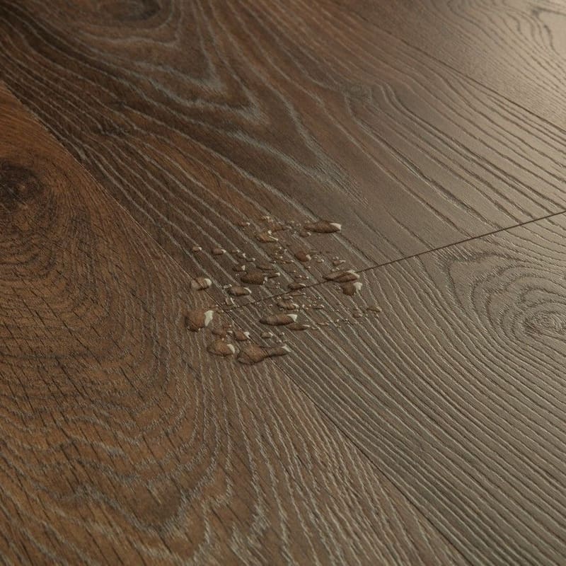 Detailed view of Quick-Step Peanut Brown Oak laminate flooring texture and grain pattern