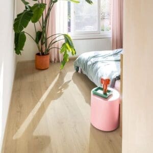 Dining area with Quick-Step Brushed Oak Beige flooring and wooden table