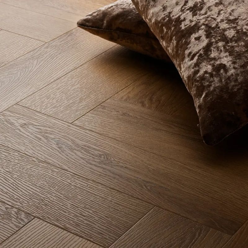 Textures traditional oak herringbone flooring with brown velvet cushion
