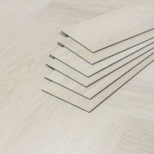 A stack of Pale Birch luxury vinyl tiles showing the 3mm thickness and profile