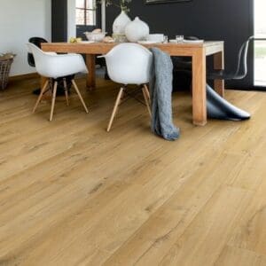Quick-Step Impressive Soft Oak Natural laminate flooring in a contemporary open-plan living space with white walls and modern furniture