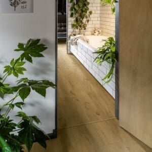 Bathroom with Quick-Step Soft Oak Natural laminate flooring, blue walls and white fixtures
