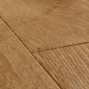 Close-up detail of Quick-Step Impressive Classic Oak Natural laminate flooring showing beveled edge