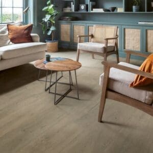Quick-Step Patina Oak Brown laminate installed in a contemporary living space with built-in shelving