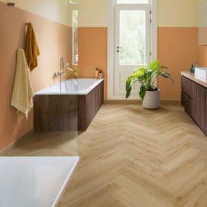 Close-up of Quick-Step Alpha Ciro Botanic Beige Herringbone showing water resistance