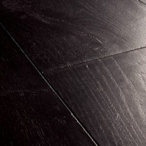 Close-up of black laminate flooring showing detailed wood grain pattern