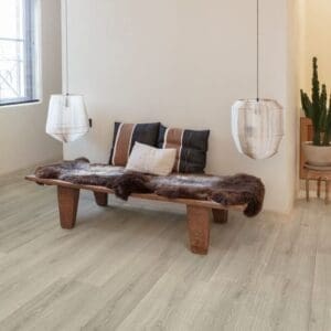 Industrial-style space with Quick-Step Capture Brushed Oak Grey laminate flooring, wooden beams and indoor plants