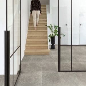 Contemporary kitchen with Dusky Bluestone laminate flooring and white cabinetry