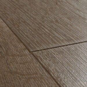 Close-up of Quick-Step Impressive Classic Oak Brown laminate flooring showing textured surface and plank connection